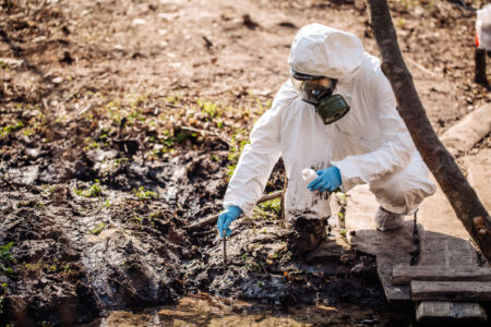 female collects soil in a test tube. soil analysis, environment, ecology concept.